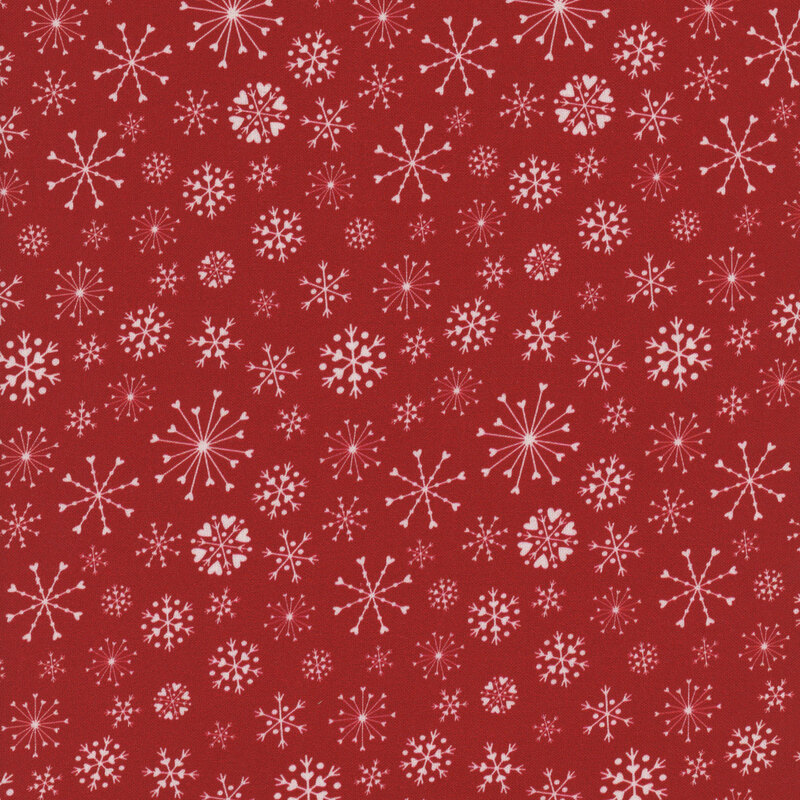 Red fabric with various white snowflake designs.