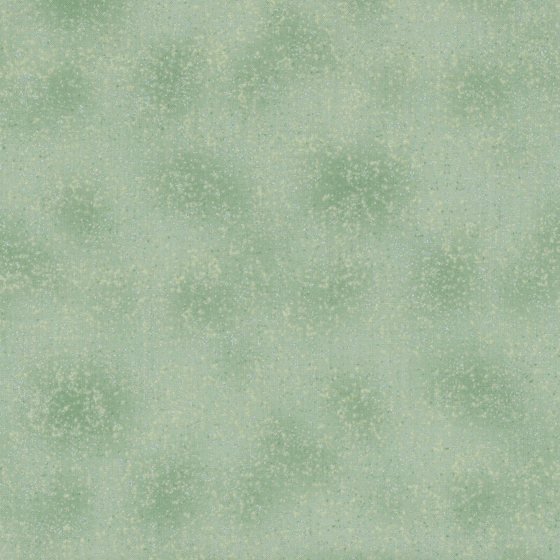 Mottled light green fabric with silver metallic stippled pin dots.