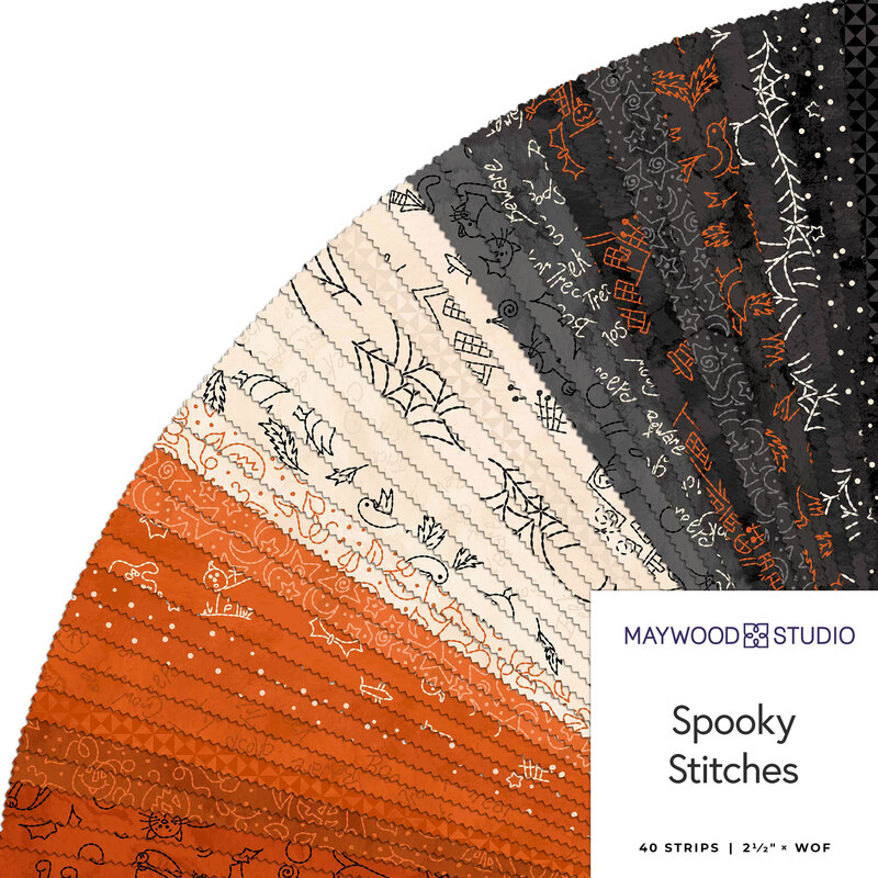 A circular arrangement of fabric strips in orange, black, and cream with Halloween-themed patterns.