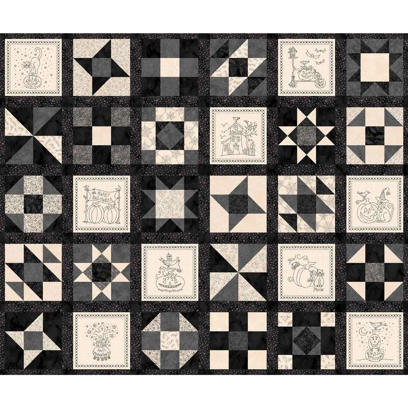 A patterned quilt featuring various black and cream blocks with intricate designs and motifs.