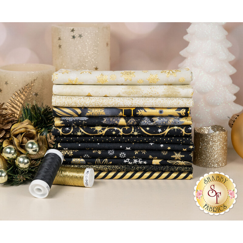 A stack of the fabrics featured in the Merry Christmas FQ set, with flowers and candles and ornaments and thread.