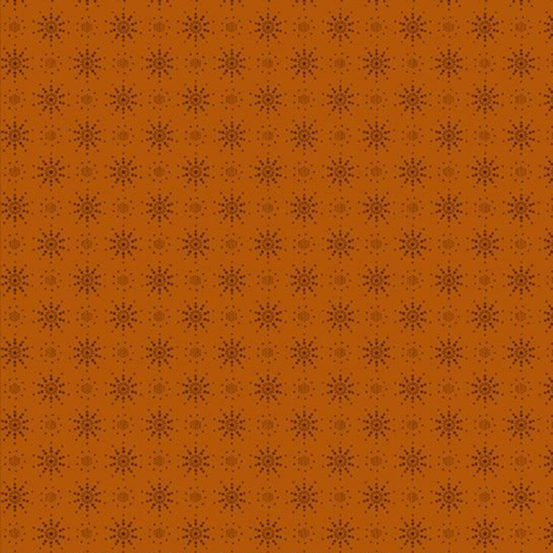 Dark orange fabric with a tonal sienna pattern of dotted sunbursts.