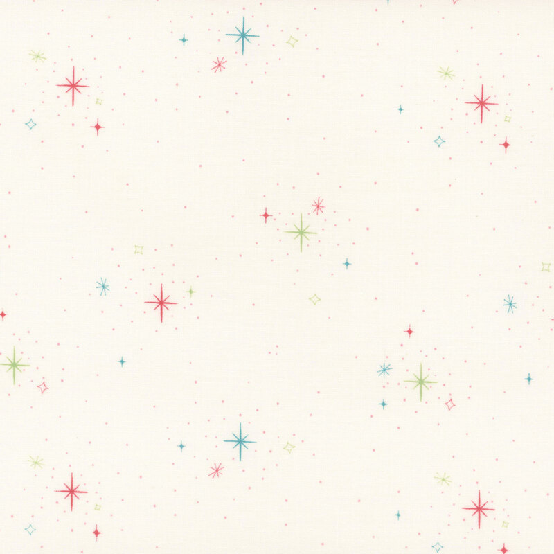 Fabric with colorful stars and sparkles on a cream background, creating a whimsical design.