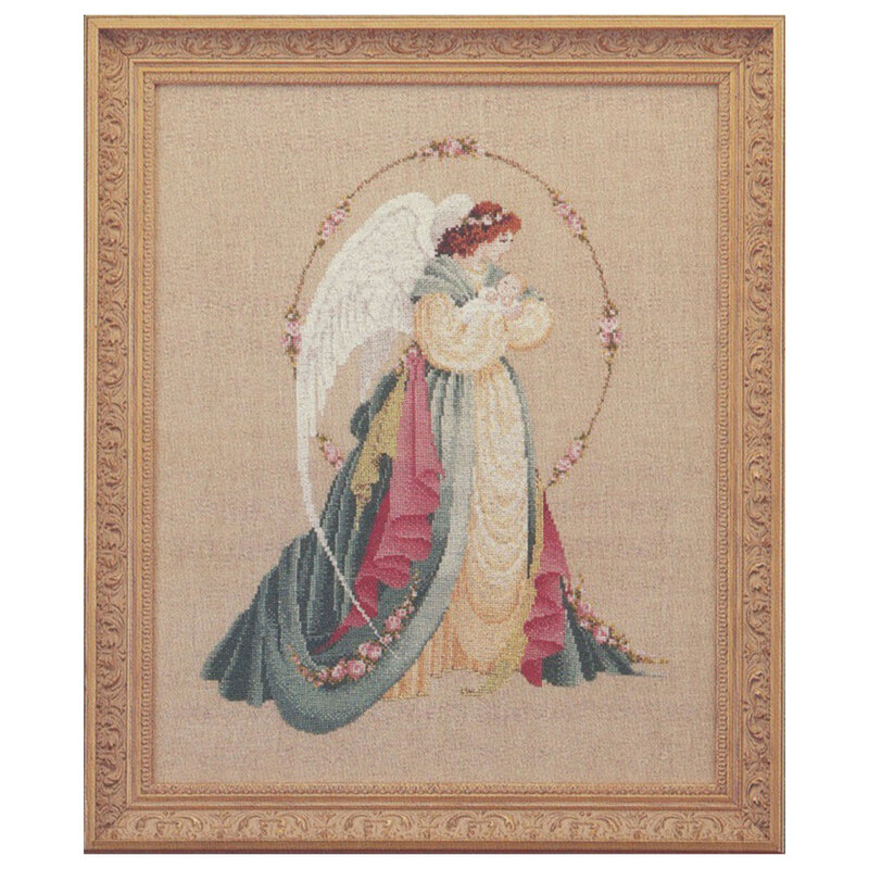 The completed Guardian Angel cross stitch hung in an ornate wooden frame.