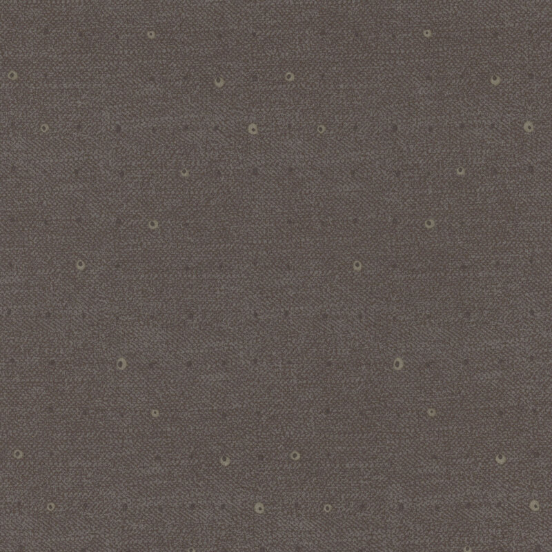 Tonal dots on a lightly textured dark gray background.