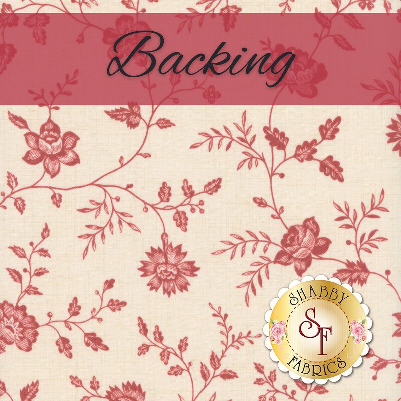 Swatch of a cream fabric with French-inspired red florals and sprawling vines. A red banner at the top reads 