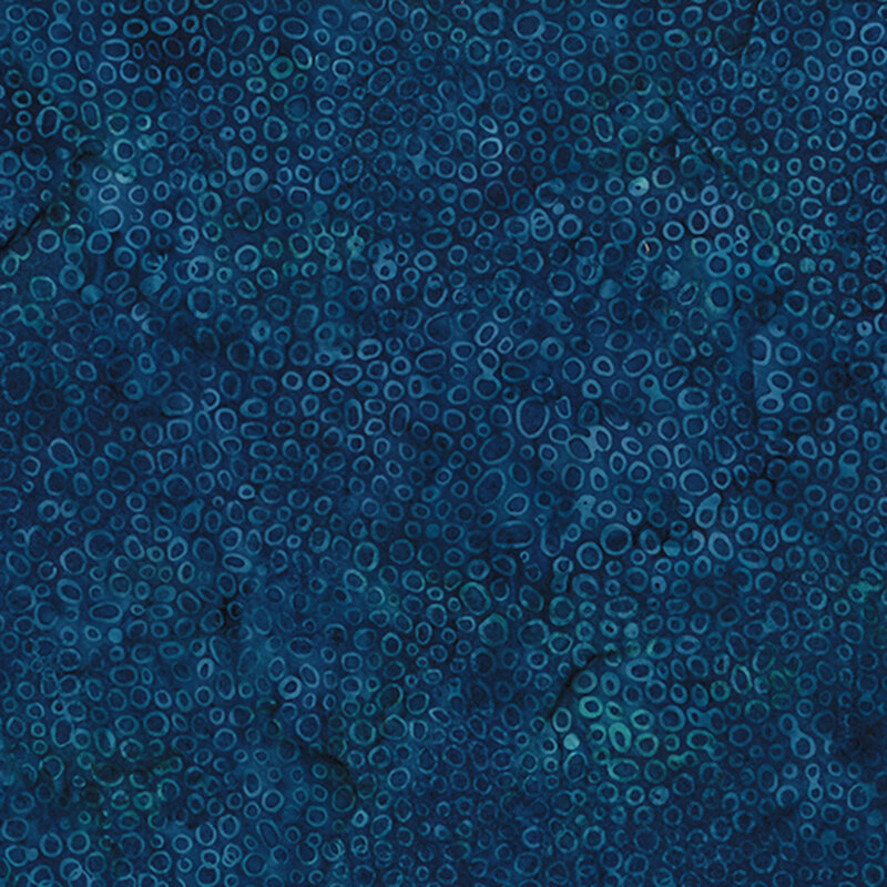 Dark blue abstract fabric with varying circular shapes and patterns throughout the surface.