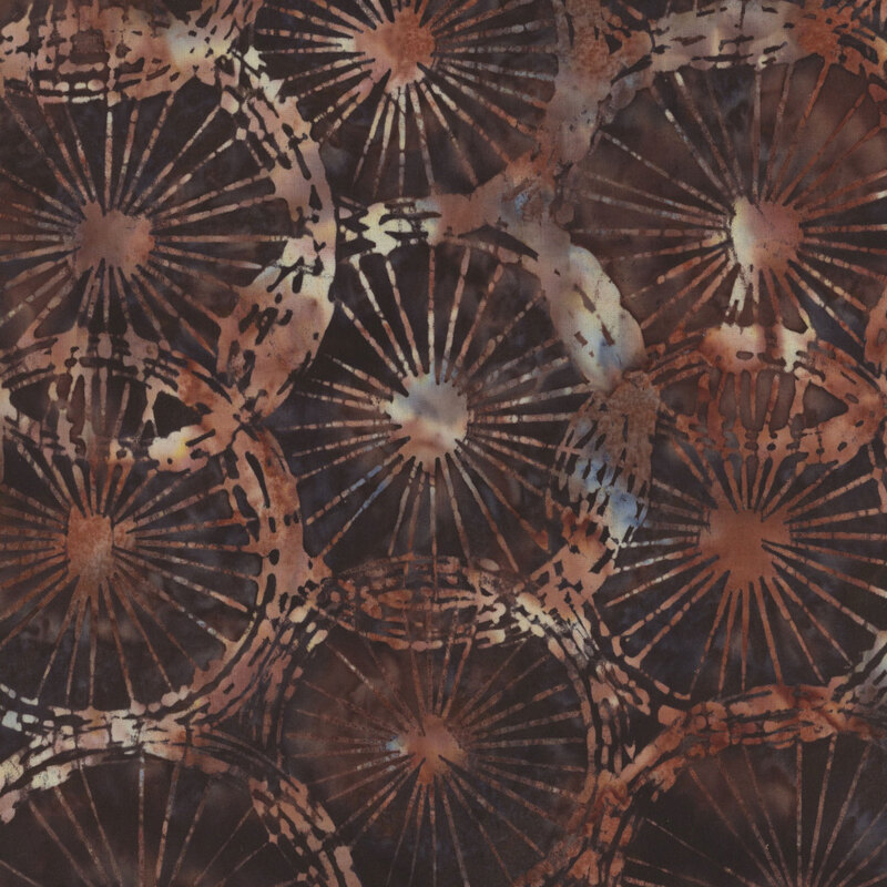 Abstract fabric pattern featuring circular motifs with radiating lines in earthy brown and purple tones on a dark background.