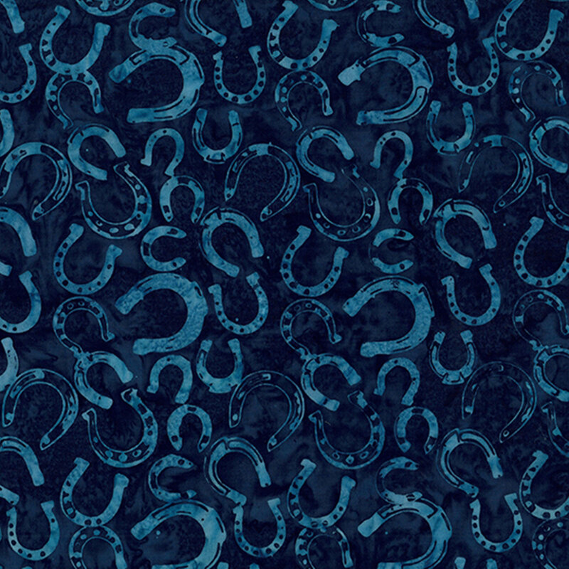 Dark blue fabric covered with various sizes of horseshoes in a repeating pattern.