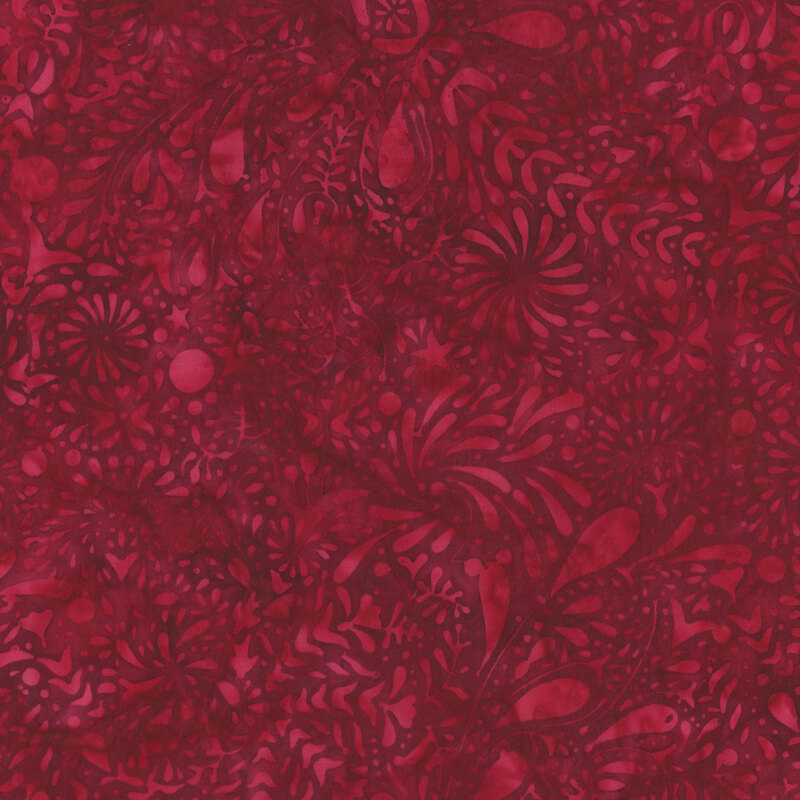 A dense, abstract fabric pattern of floral and swirling shapes in various shades of deep pink.