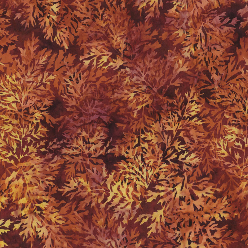 A vibrant fabric with orange and yellow leaves against a dark background, evoking autumn foliage.