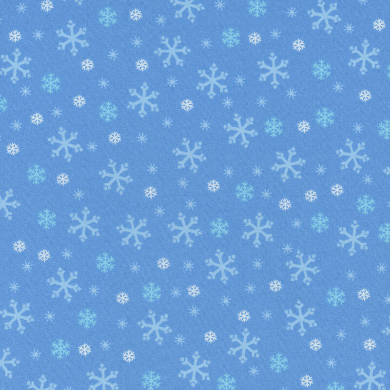 Light blue fabric with tossed white, tonal blue, and cyan snowflake designs.