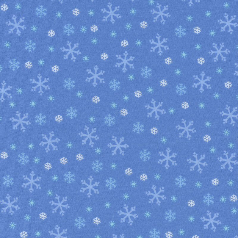 Periwinkle blue fabric with tossed white, tonal blue, and cyan snowflake designs.
