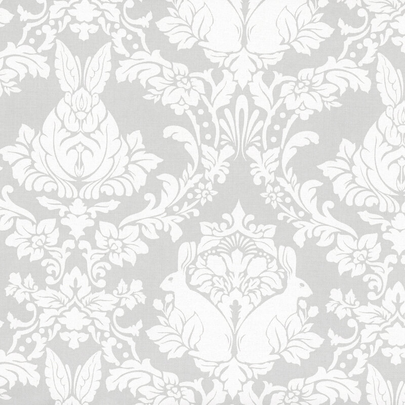 Fabric swatch with a damask pattern of white rabbits and floral designs on a light gray background.