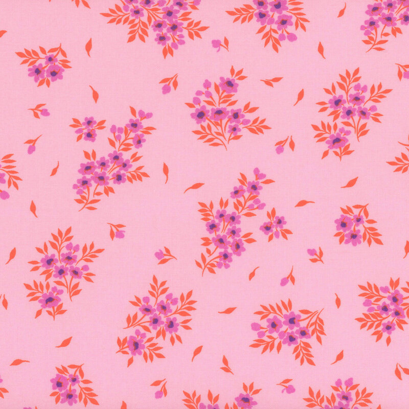 Fabric swatch of a light pink fabric with tossed tonal clusters of magenta flowers and orange leaves.