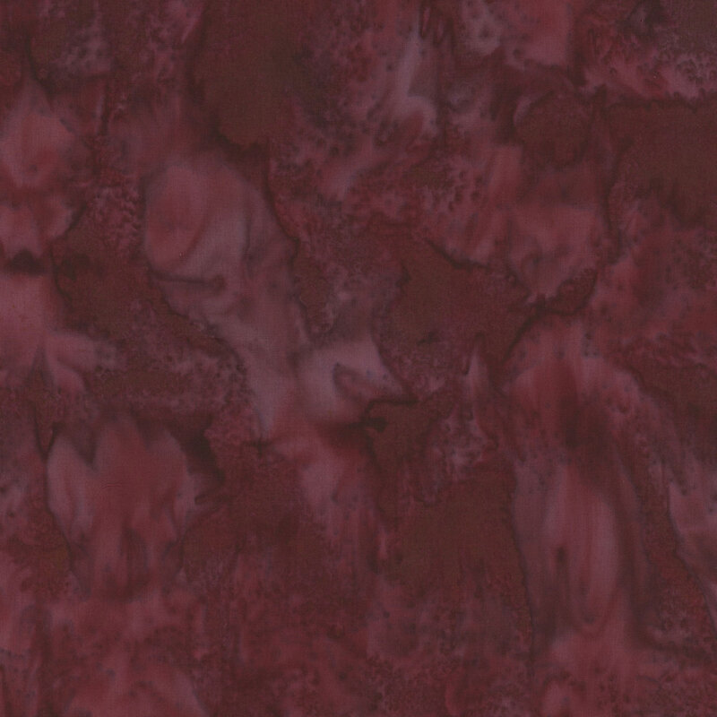 fabric with deep burgundy tones with swirling, marbled patterns.