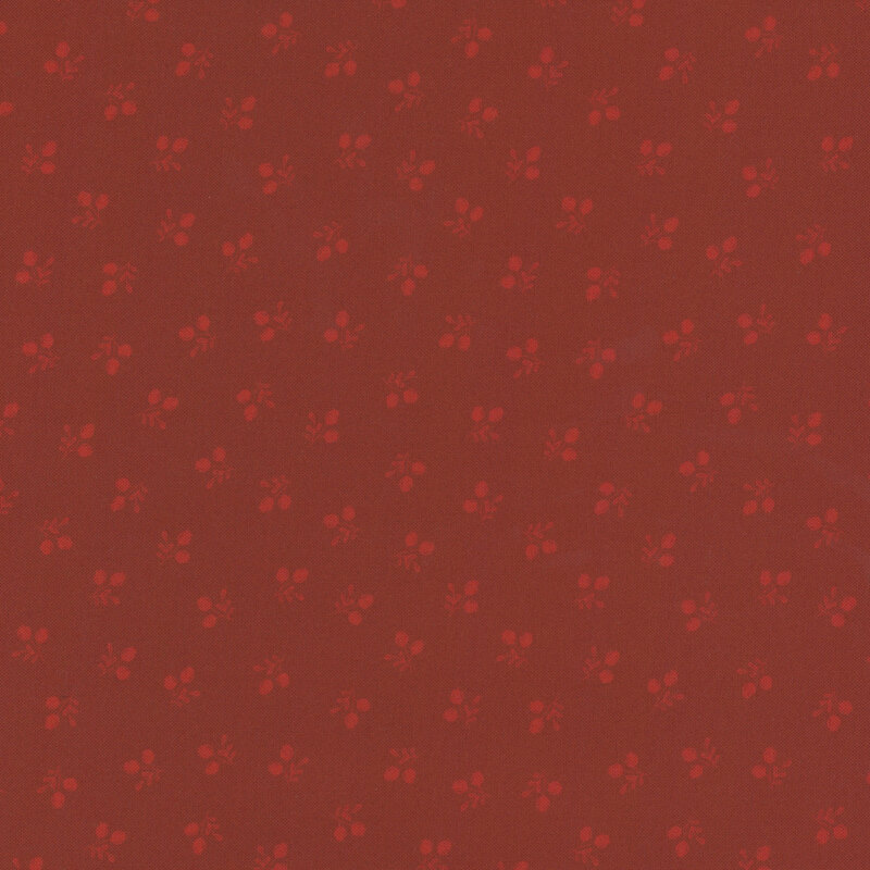 Pattern of small floral motifs in shades of red on a darker red background.