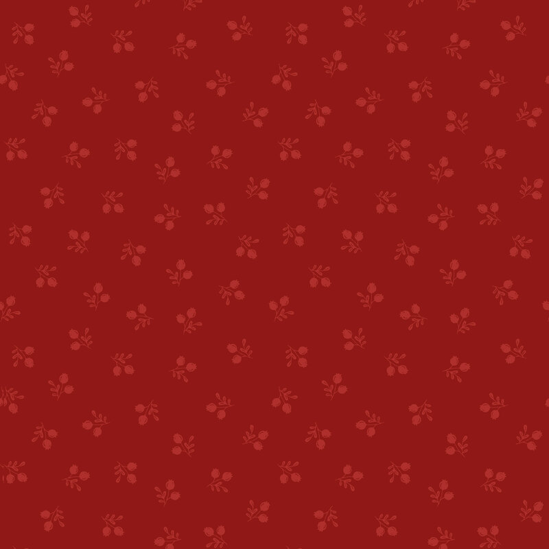 Pattern of small floral motifs in shades of red on a darker red background.