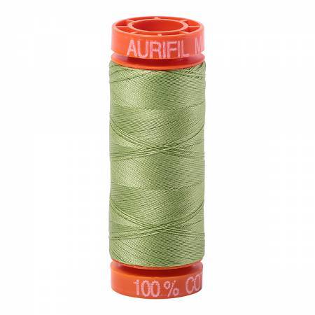 Light Green thread on an orange spool, isolated on a white background