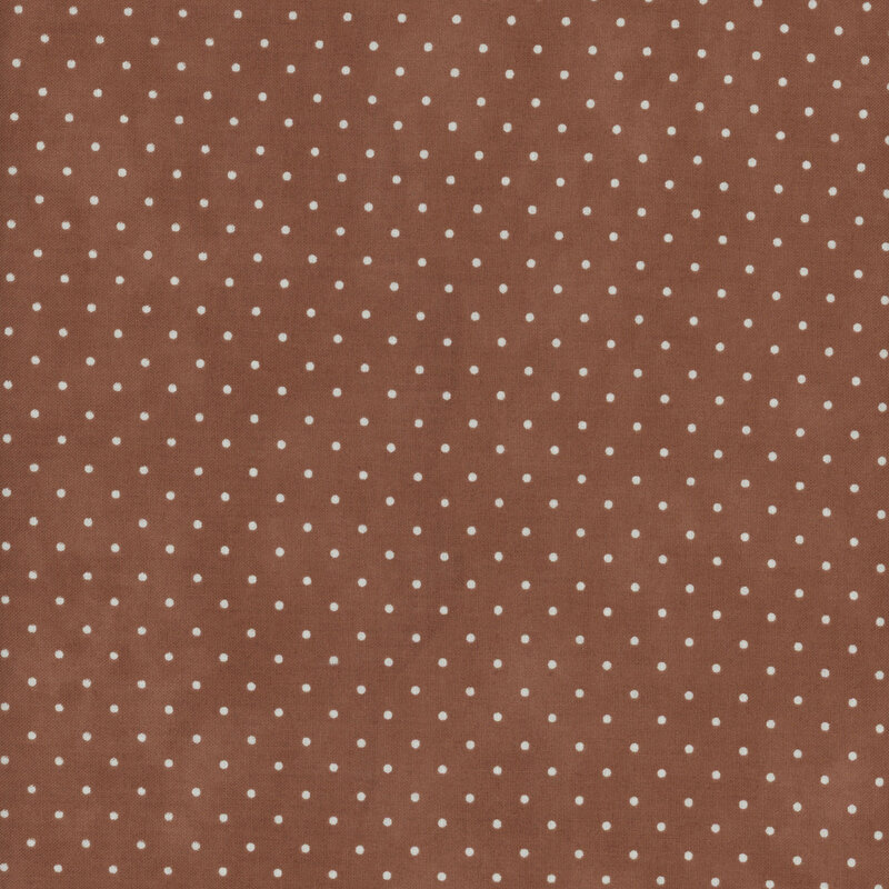 Light brown mottled fabric with an even pattern of polka dots.