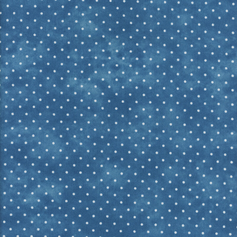 Mottled blue fabric with an even pattern of polka dots.