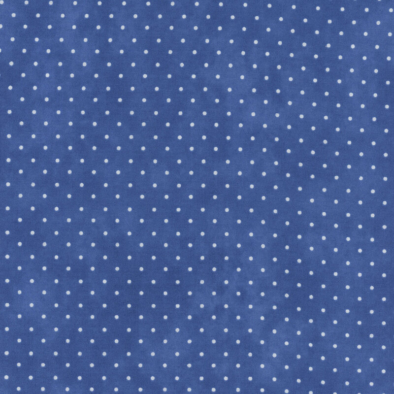 Blue mottled fabric with an even pattern of polka dots.