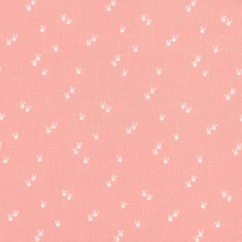 Light pink fabric with a repeated pattern of small white bunny silhouettes.