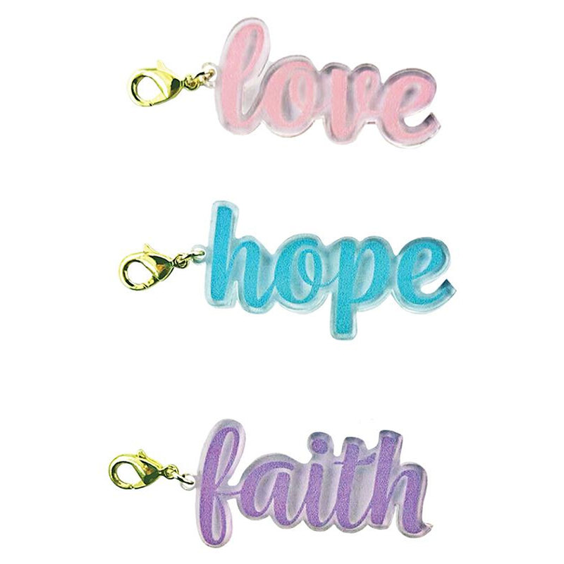 Three colorful keychain charms displaying the words love, hope, and faith in stylized fonts.