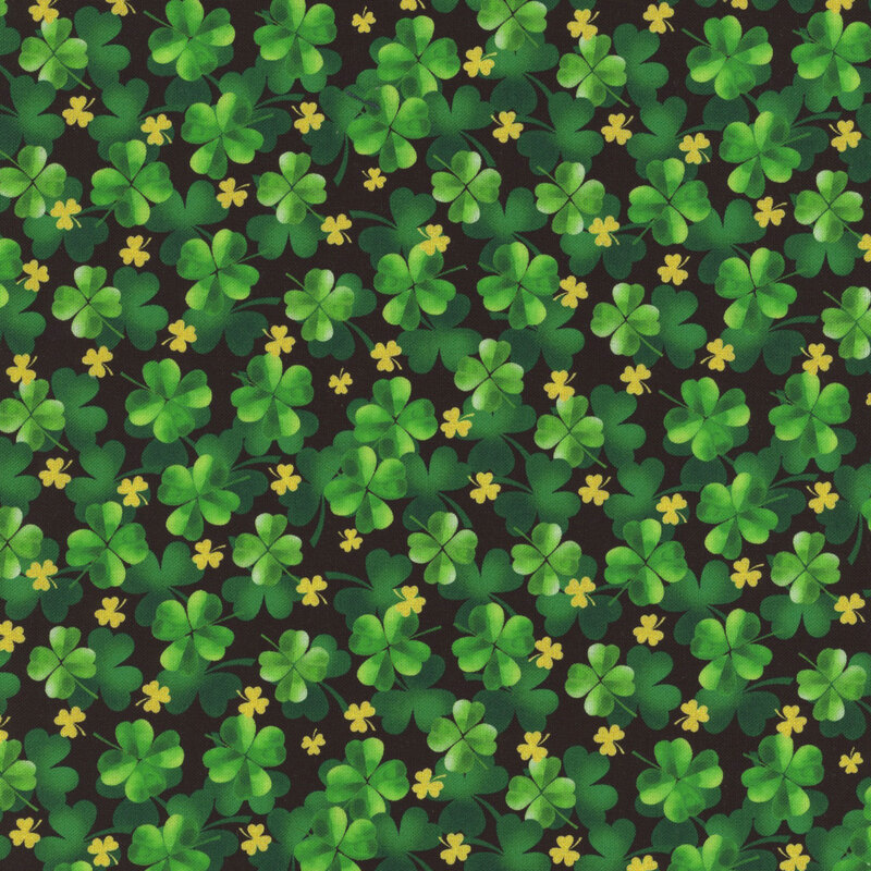 Black fabric with layers of green and gold shamrocks.