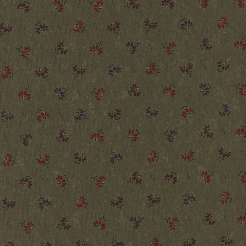 Green fabric with a scattered floral pattern in red, yellow, and blue on a textured background.