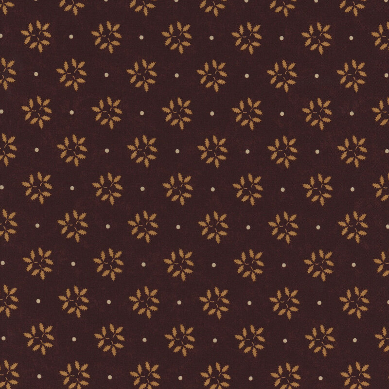 Brown fabric with a repeating pattern of yellow flowers and small white dots. Ruler at the bottom.