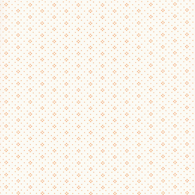 Light cream fabric with a dense pattern of small orange dots evenly distributed throughout.