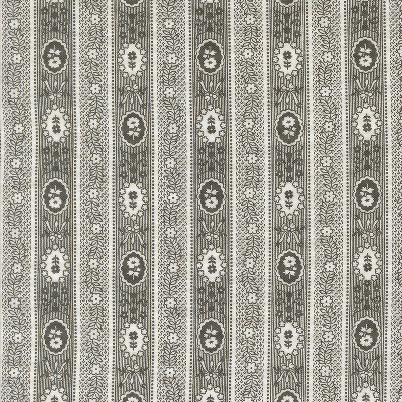 Patterned textile featuring vertical stripes with floral and oval motifs in gray and cream.