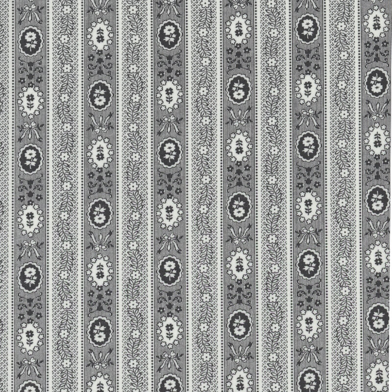 Patterned textile featuring vertical stripes with floral and oval motifs in gray and cream.