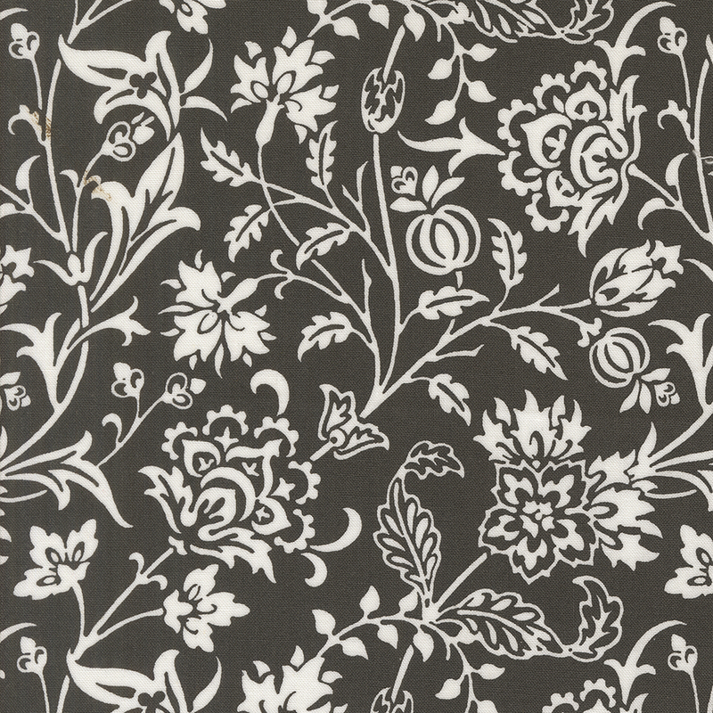 Black fabric with a white floral pattern featuring various flowers and leaves throughout.