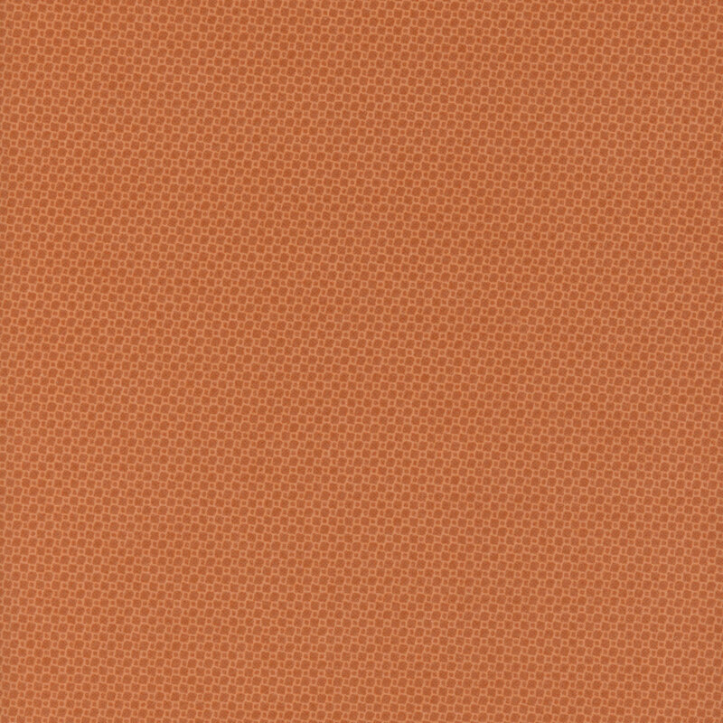 Orange fabric with a subtle, textured pattern of tiny squares.