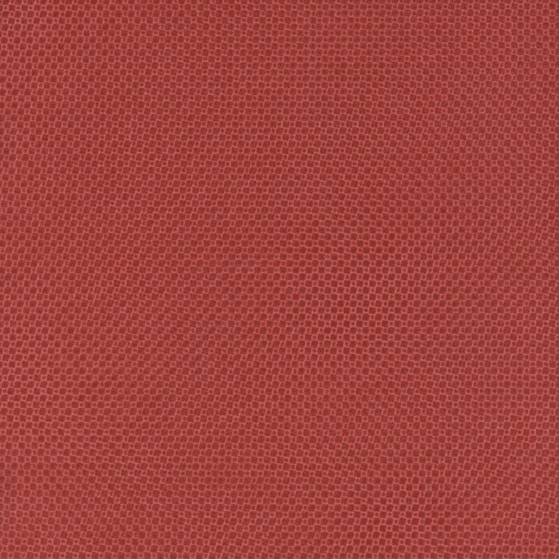 Red fabric with a subtle, textured pattern of tiny squares.