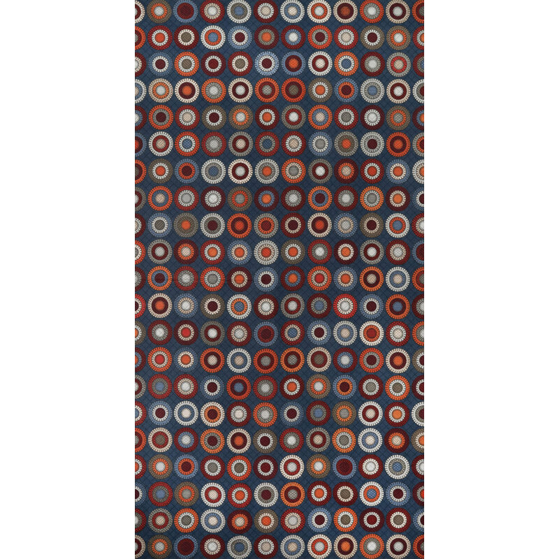 Pattern of colorful concentric circles in red, blue, and silver on a dark blue fabric.