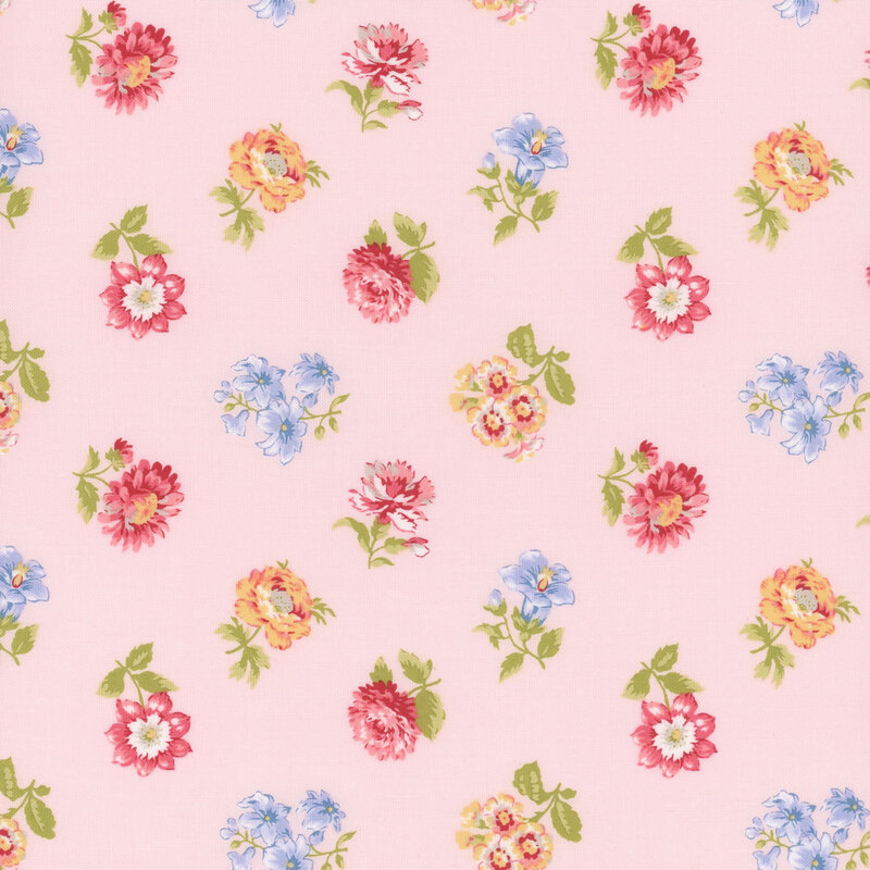 A pink fabric with a scattered pattern of colorful flowers, including reds, yellows, and blues.