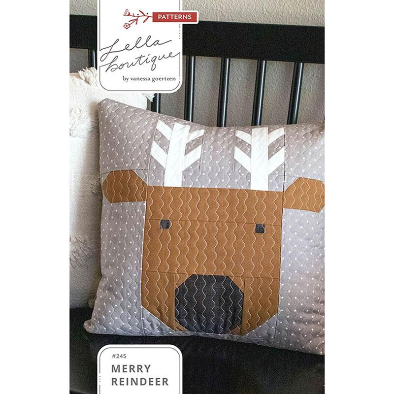 Front of the pattern featuring a decorative pillow with a quilted reindeer face and antlers, on a gray polka dot background.