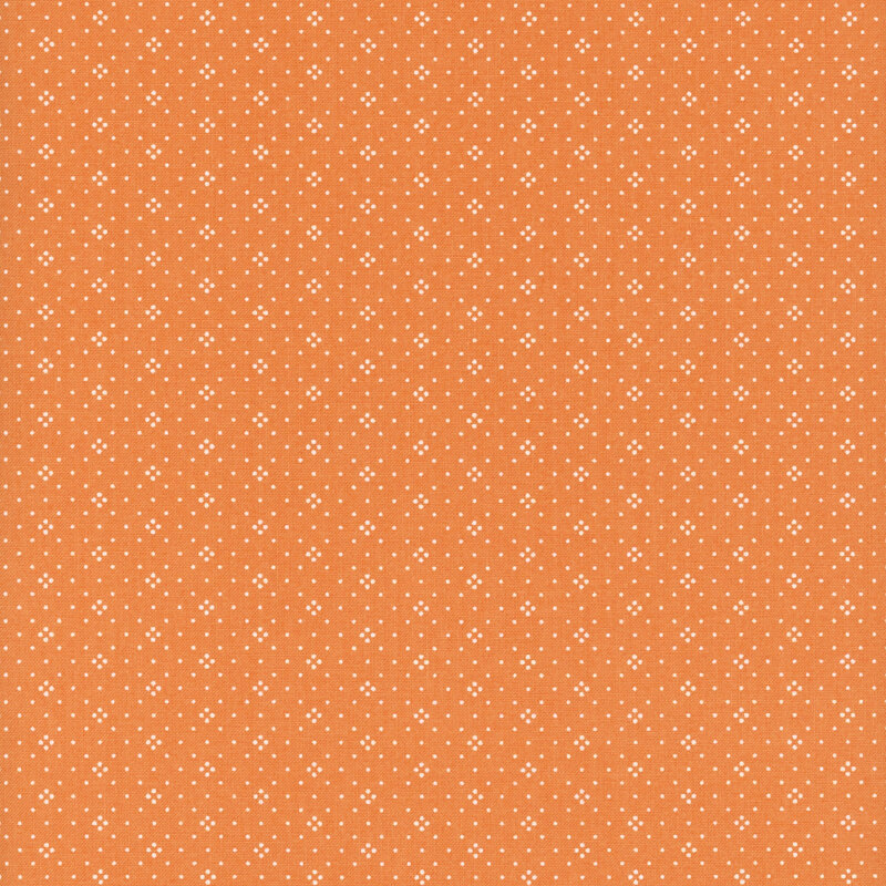 A orange fabric with a consistent pattern of small white dots.