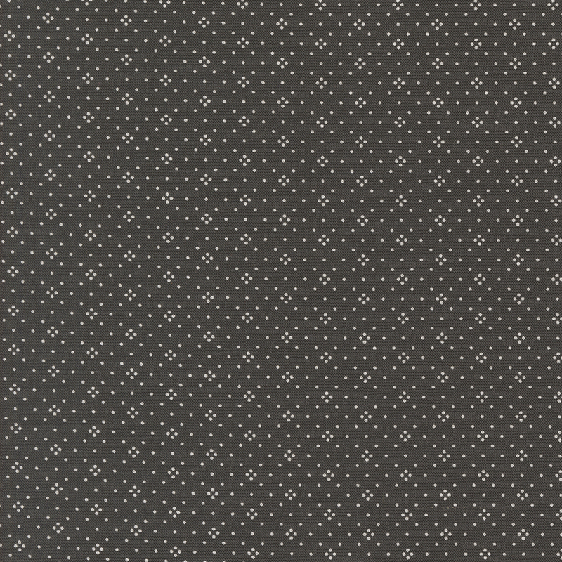 Black fabric with a repeated pattern of small white dots.