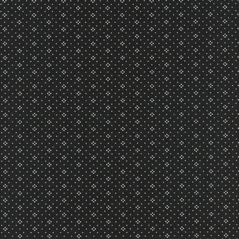 Black fabric with a repeated pattern of small white dots.