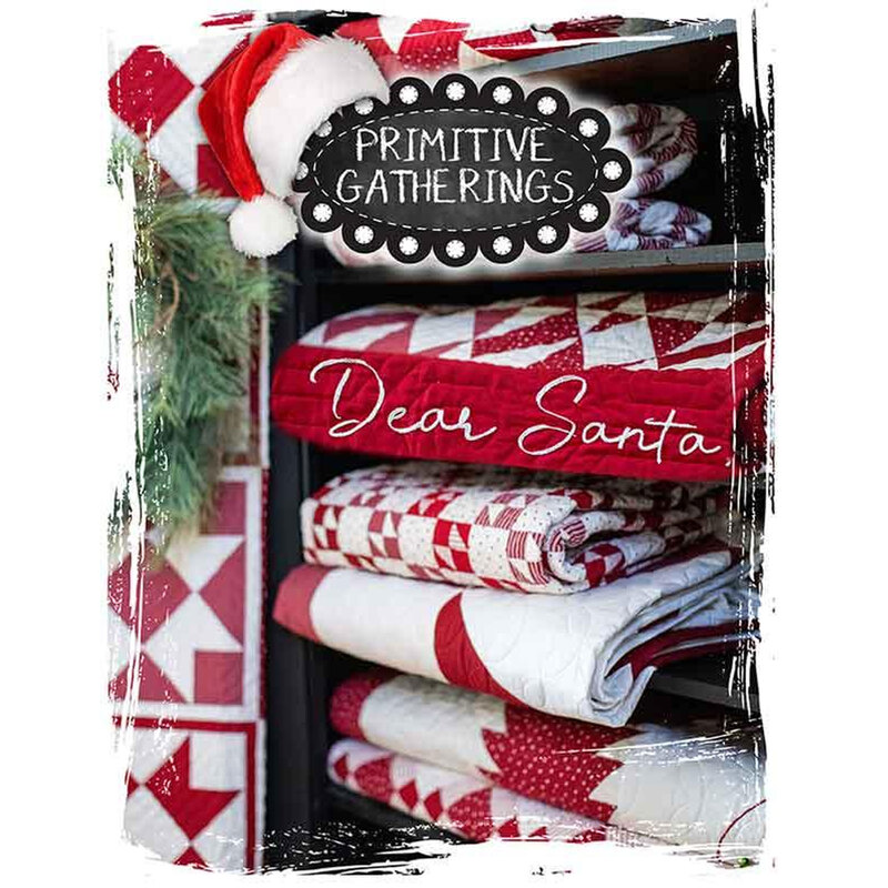 A display of red and white quilts on shelves, with holiday decor and Dear Santa text.