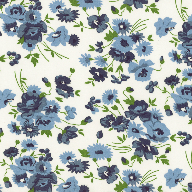 A fabric pattern featuring various blue flowers and green leaves on a white background.