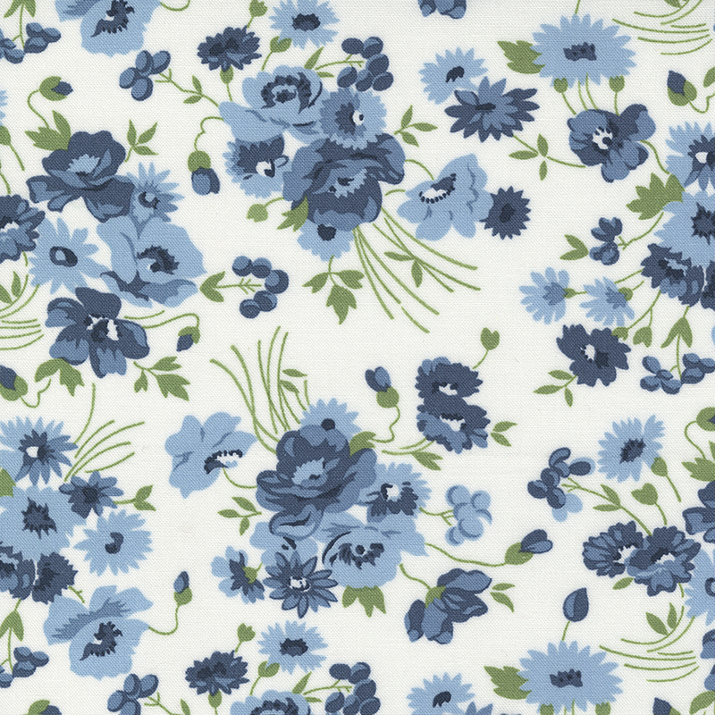 A fabric pattern featuring various blue flowers and green leaves on a white background.