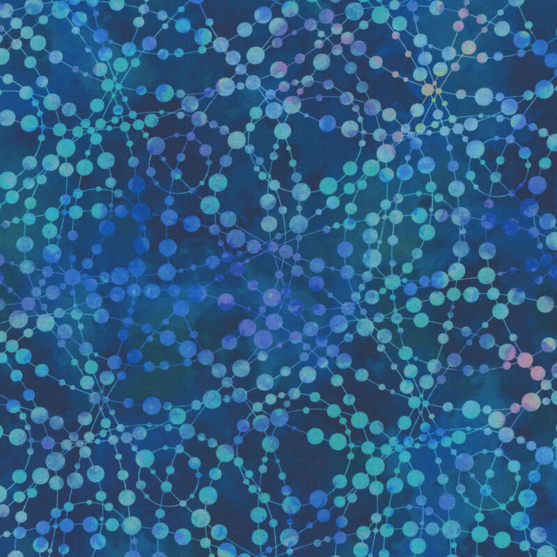 Mottled blue fabric with an abstract beaded design connected across the background.