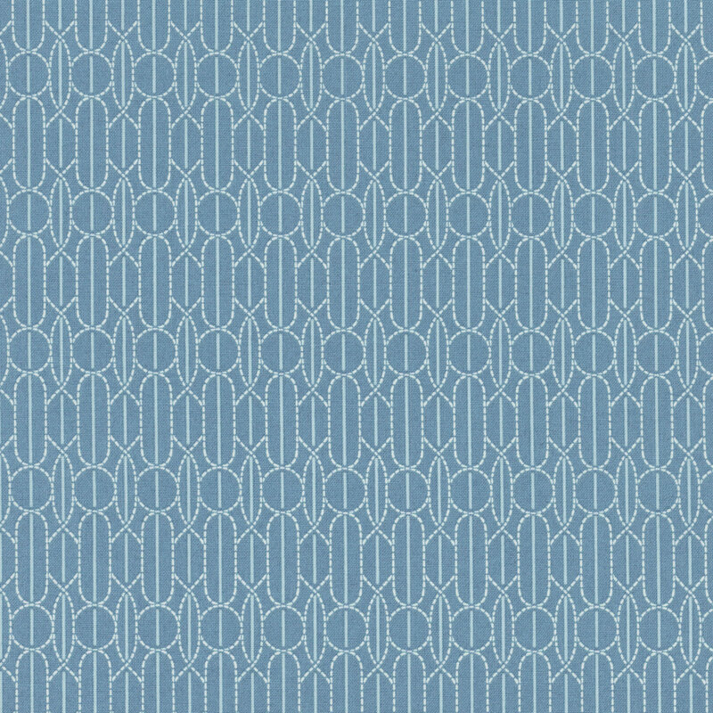 Repeating geometric pattern featuring light blue oval shapes on a deep blue fabric.