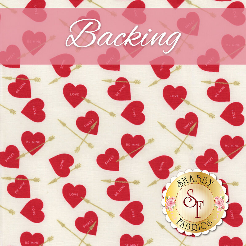 A swatch of cream fabric with red hearts featuring candy heart sayings and tossed golden arrows scattered across the fabric. A pink banner at the top reads 