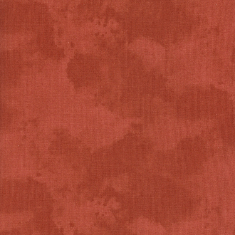 Abstract fabric in shades of red with soft, blended patterns.